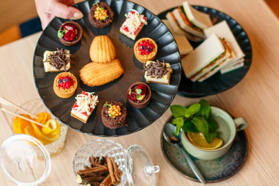 A bird's eye view of a high tea in the ballroom with sweet pastries