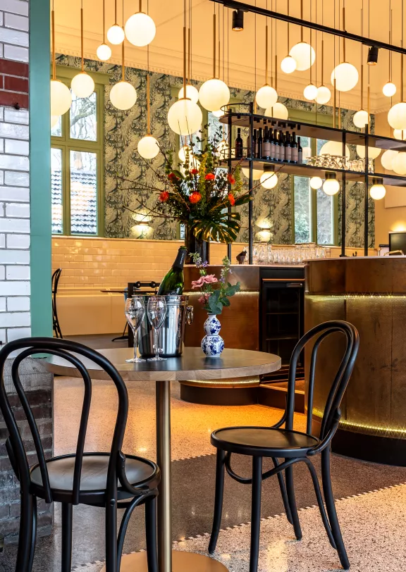 A table with chairs with glasses for drinks