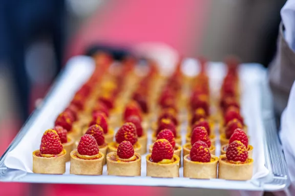 Kleine gouden hapjes op schaal met framboos