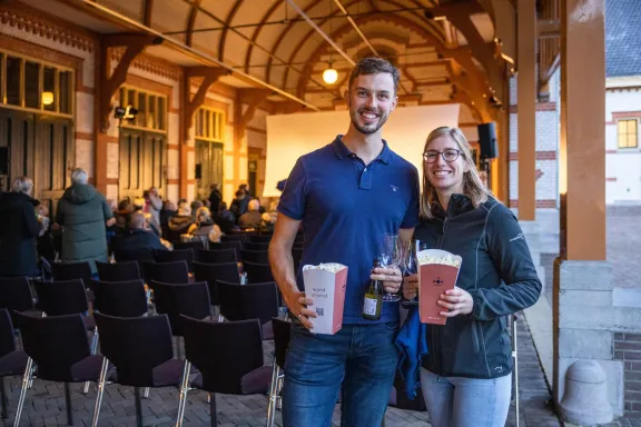 People hold their popcorn and drinks as they wait for the film to start during Movie Nights at Paleis Het Loo