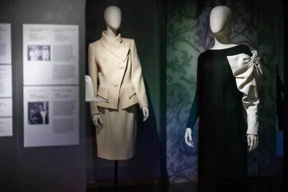Links een wit kostuum gedragen door Prinses Irene bij de uitvaart van Prins Bernhard in 2004, rechts een zwarte jurk gedragen door prinses Mabel met een witte strik gedragen tijdens de inhuldiging van Willem-Alexander als Koning der Nederlanden.