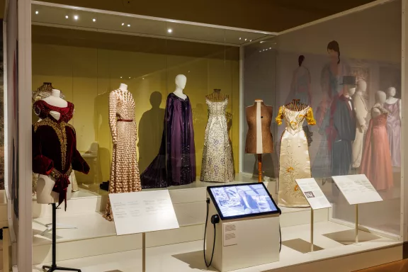 Verschillende mannequins met delen van jurken waaronder een Jan Taminiau haute couture jurk uit de Spring 2014 collectie en de paarse avondjurk van koningin Emma ontworpen door Nicaud & cie uit 1926