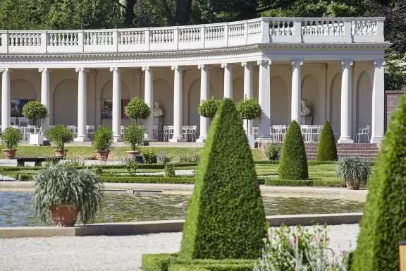 The colonnades in the garden with chairs where customers can sit for food or drinks